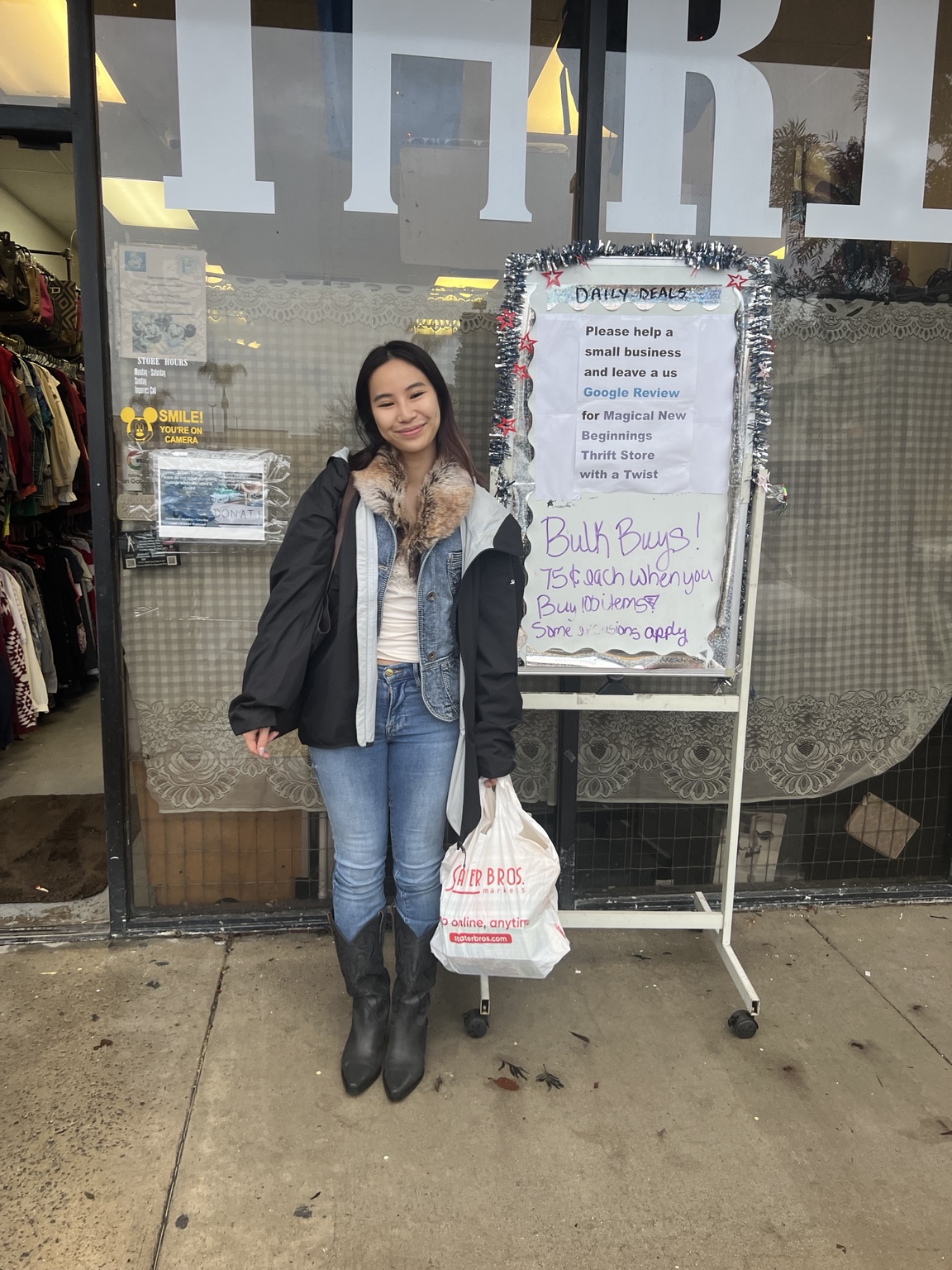 A community member outside the thrift shop holding a bag